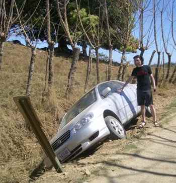Montezuma Car Rental - This is a photo of my friend Alex, who put his rental car into a ditch because he was driving too fast.  Both he and the car were undamaged.  These roads can be slippery even when they're dry.