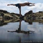 Yoga pose reflected in a tidepool